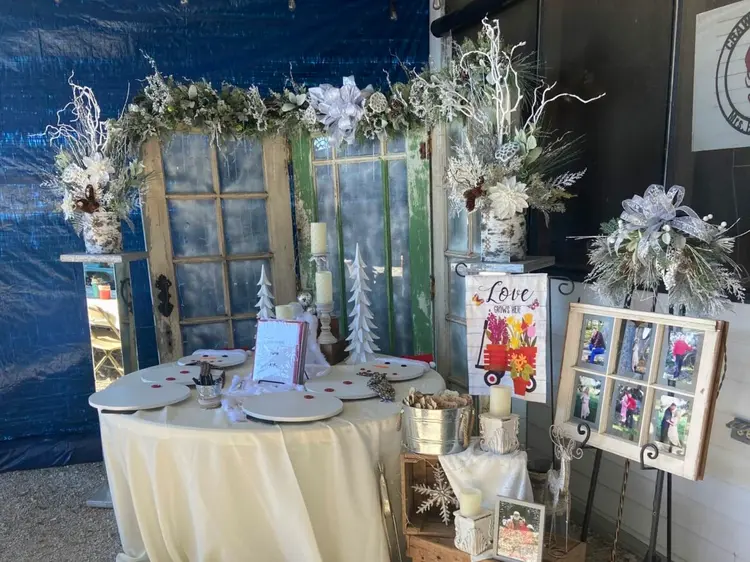 A beautifully decorated table with various festive elements, framed photos, and winter-themed decorations.