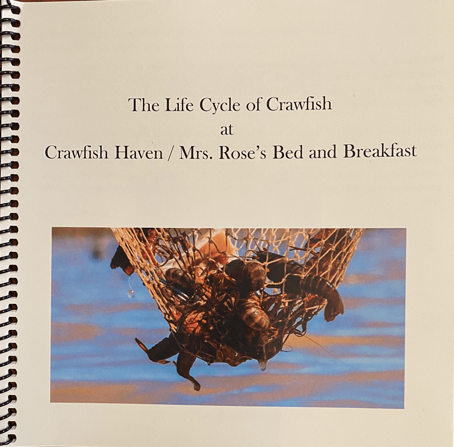 Cover page of a booklet titled "The Life Cycle of Crawfish" at Crawfish Haven/Mrs. Rose's Bed and Breakfast, featuring a photo of crawfish in a net.