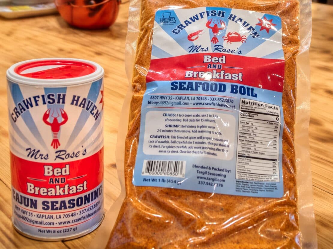 A can of Cajun seasoning and a bag of seafood boil mix, both labeled "Mrs. Rose's Bed and Breakfast."