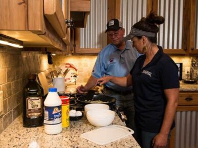 Barry teaching lady to cook at Crawfish Haven Mrs. Rose's Bed and Breakfast