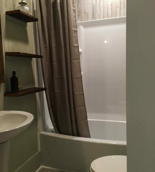 bathroom with brown shower curtain in Cypress Bedroom